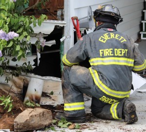 A firefighter examines damage